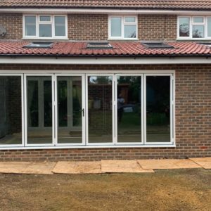 Lean to orangery with white bifold door